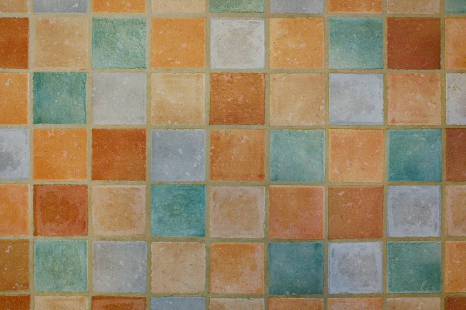 Close-up of hand laying large-format porcelain tiles